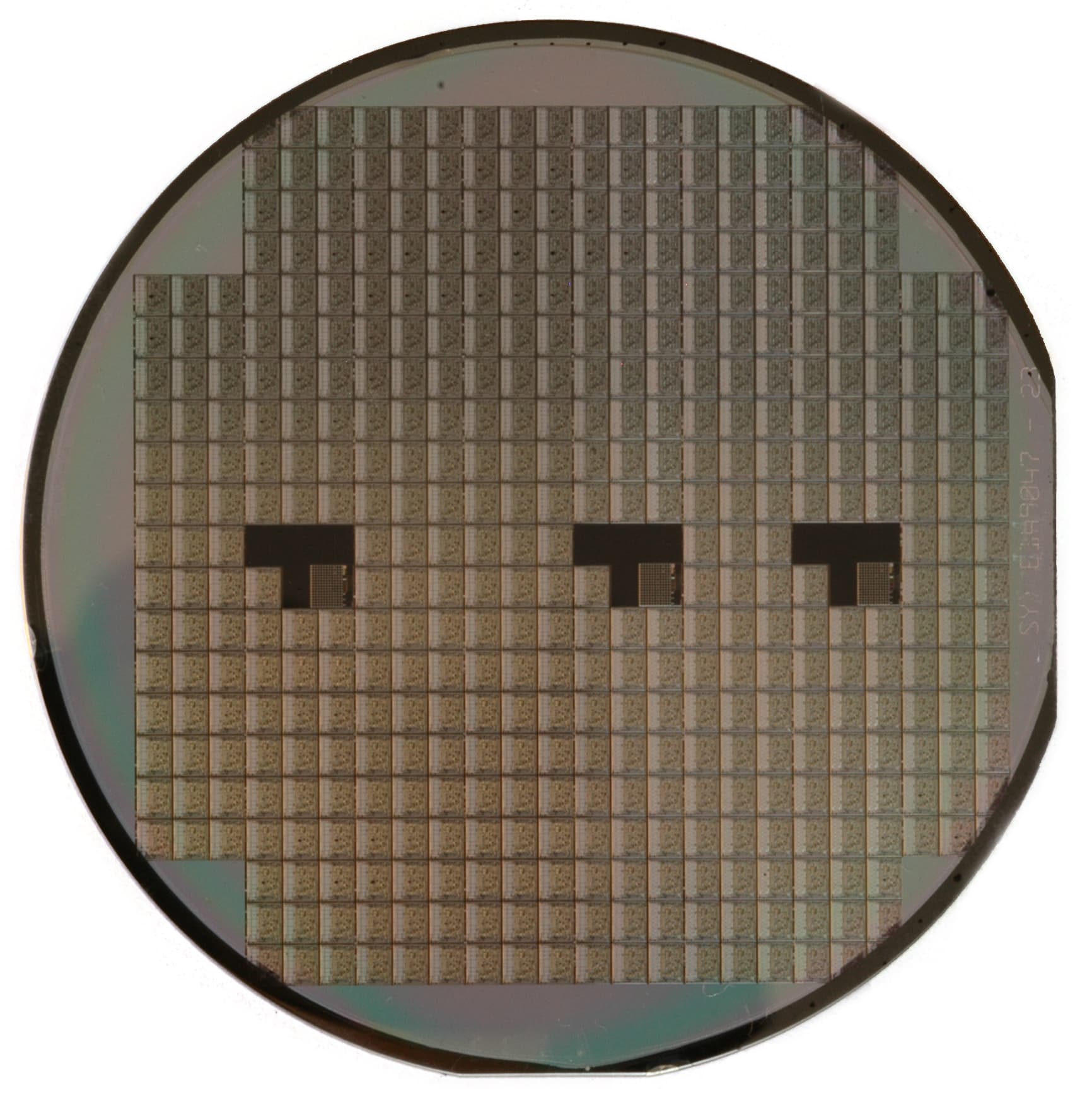 Photograph of a circular silicon wafer patterned with many semiconductor dies.