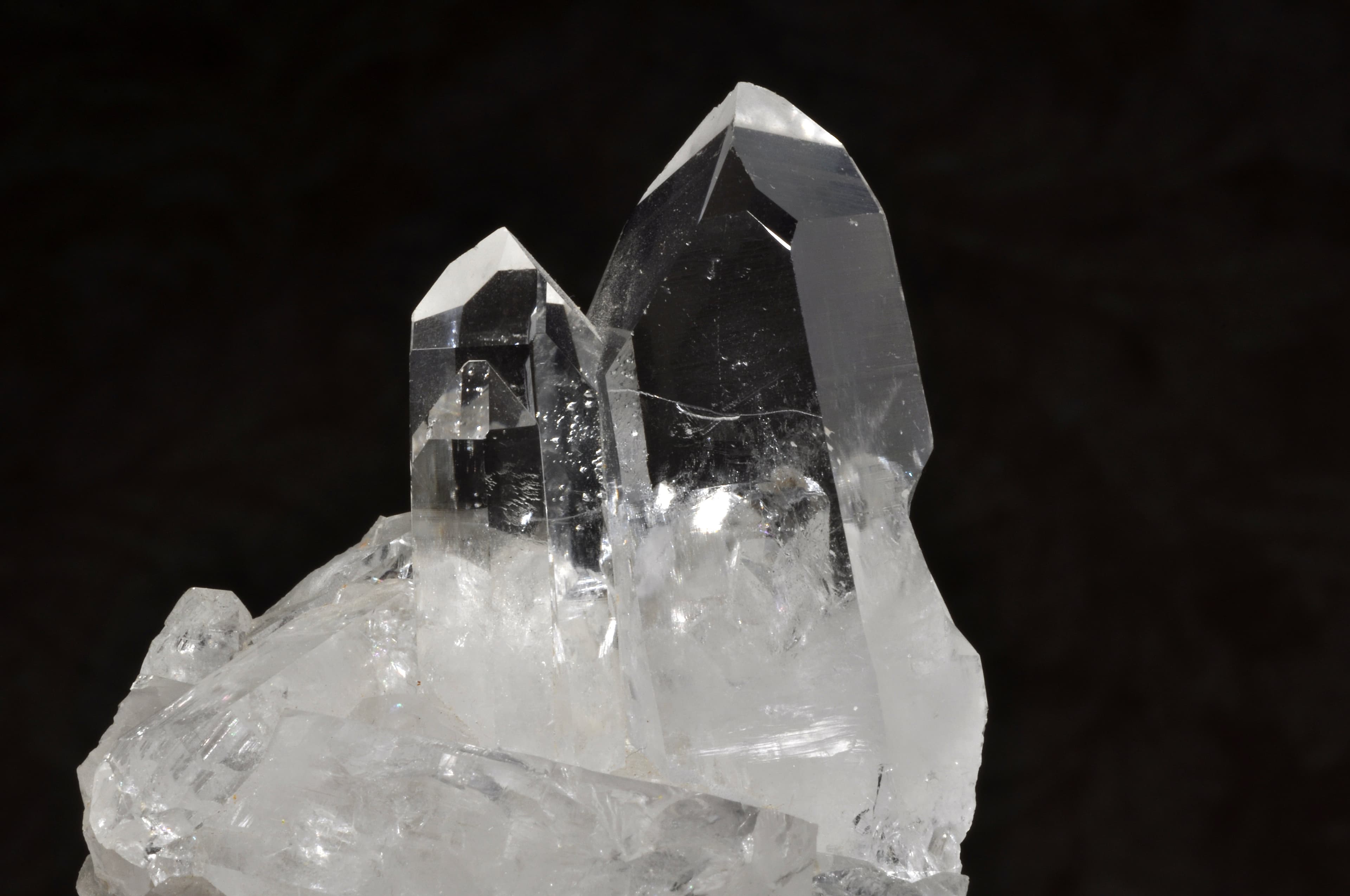 High-resolution photograph of clear quartz crystals, a natural crystalline form of silicon dioxide or silica.